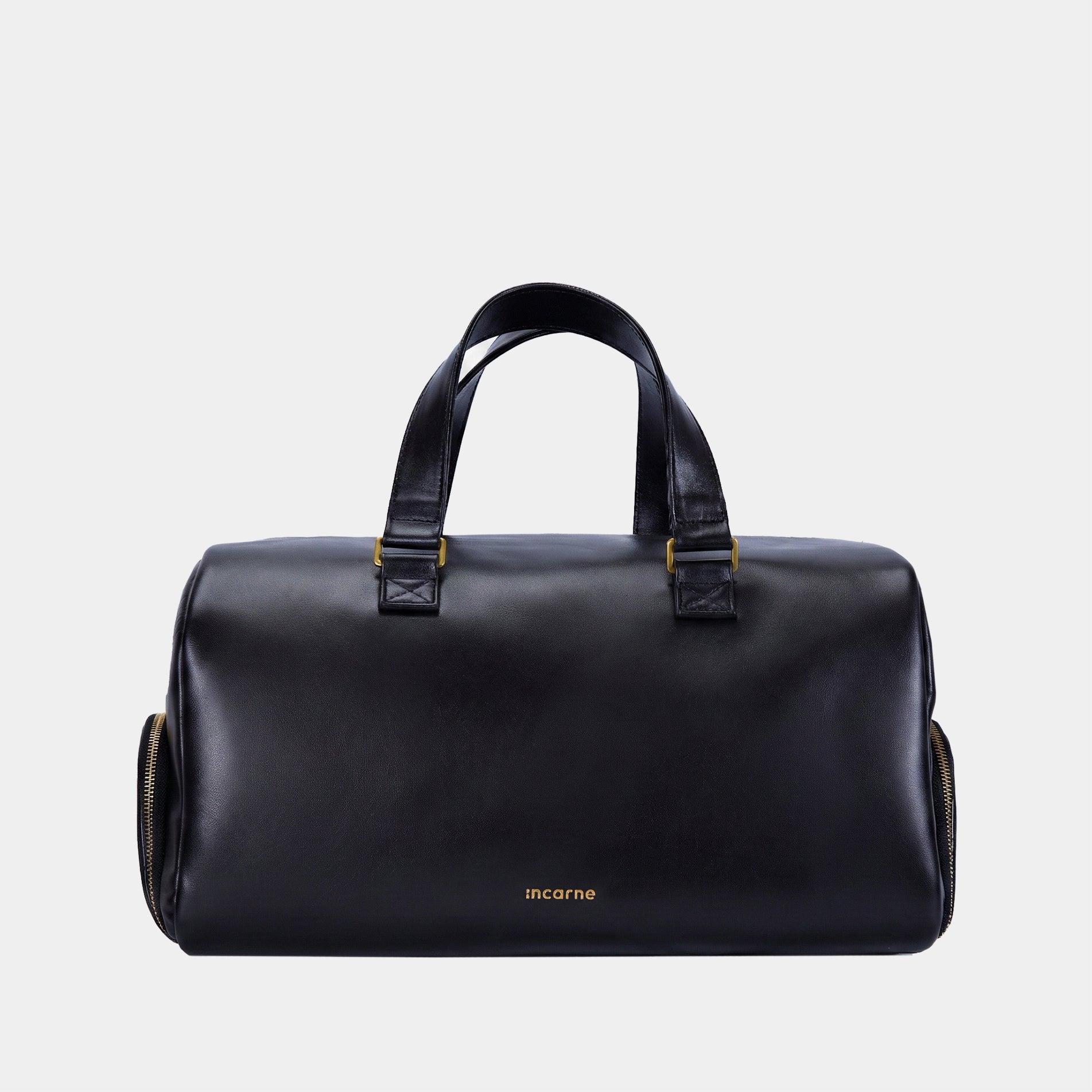 Nomad black leather travel bag by INCARNE on neutral background with two top handles and detachable shoulder strap
