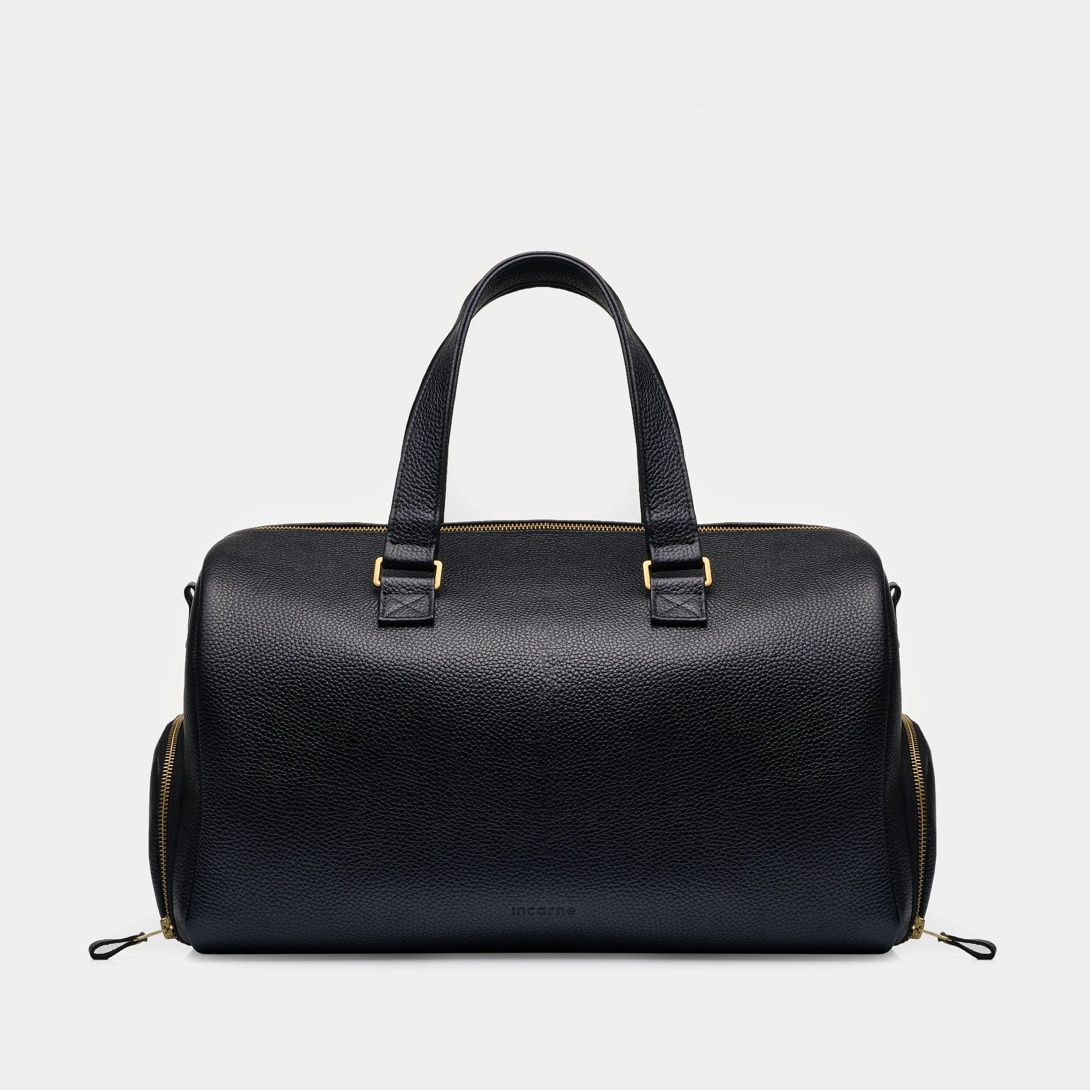 INCARNE Nomad black pebbled leather travel bag in size M shown on white background